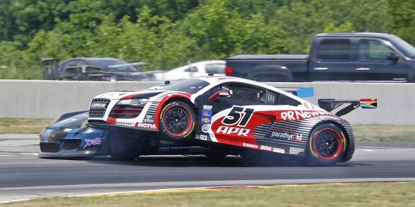 APR's Audi R8 climbs up the left side of TRG Porsche.